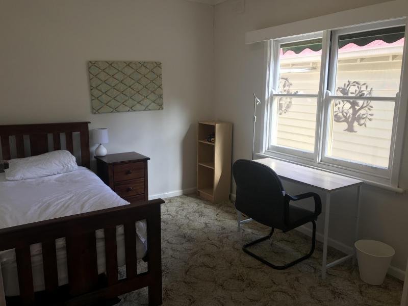 Bedroom 1 - single bed, bedside table, desk, light, built in robes